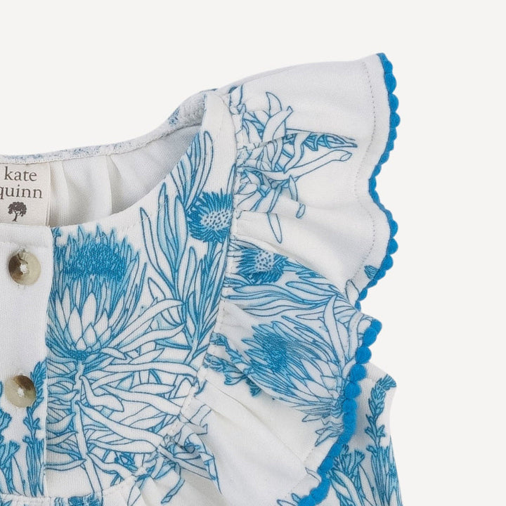 sleeveless ruffle button pom pom bubble | blue proteas | organic cotton interlock