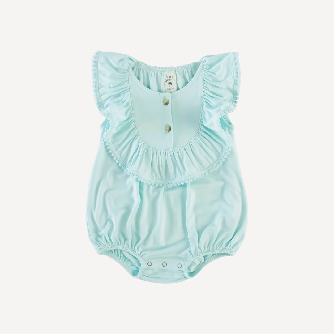 sleeveless ruffle button pom pom bubble | sea mist | bamboo – kate quinn