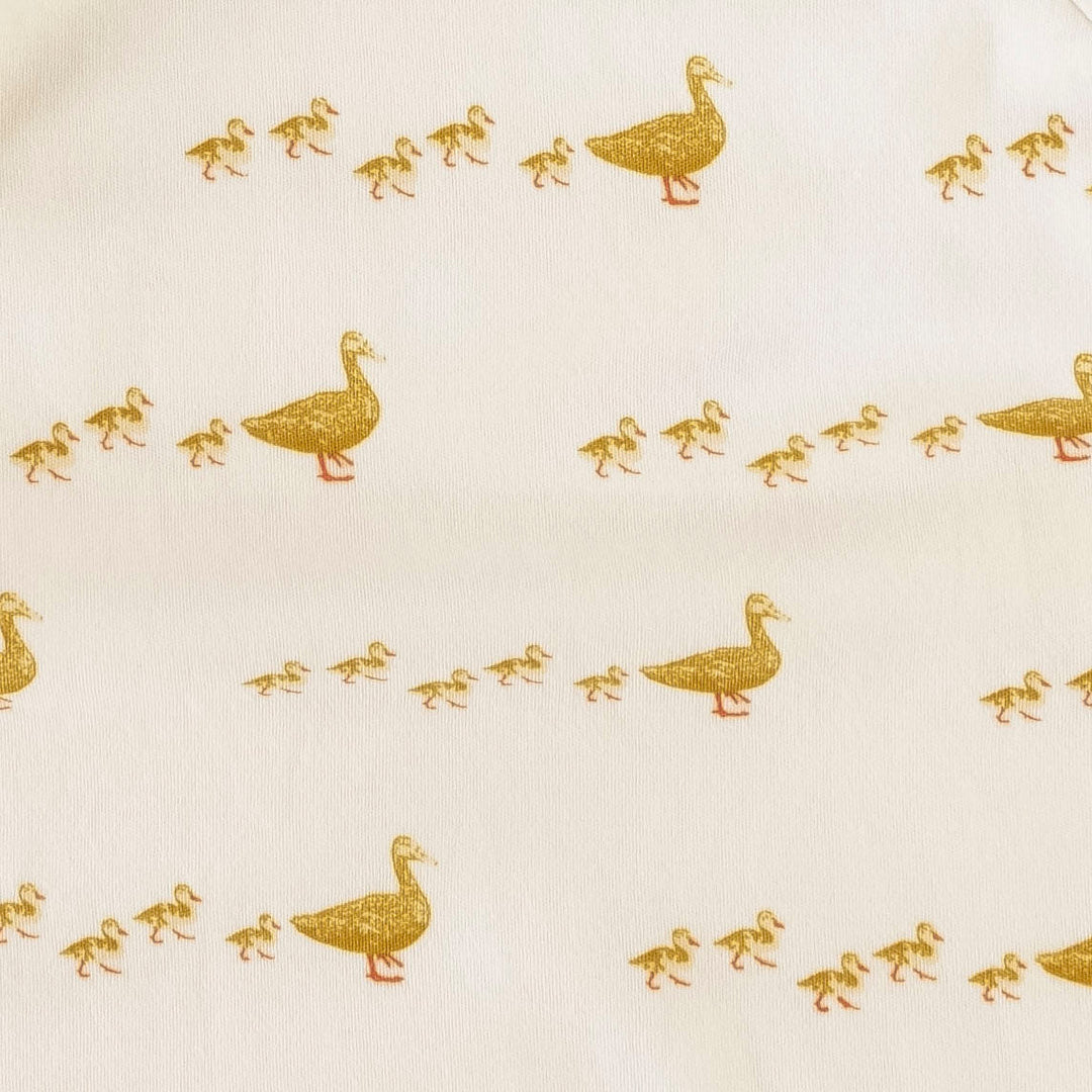 sleeveless ruffle button pinafore shortie | ducks | organic cotton interlock