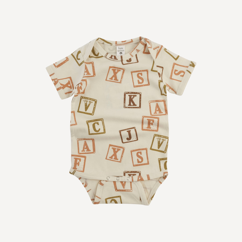 short sleeve lap neck bodysuit | neutral alphabet blocks | organic cotton jersey