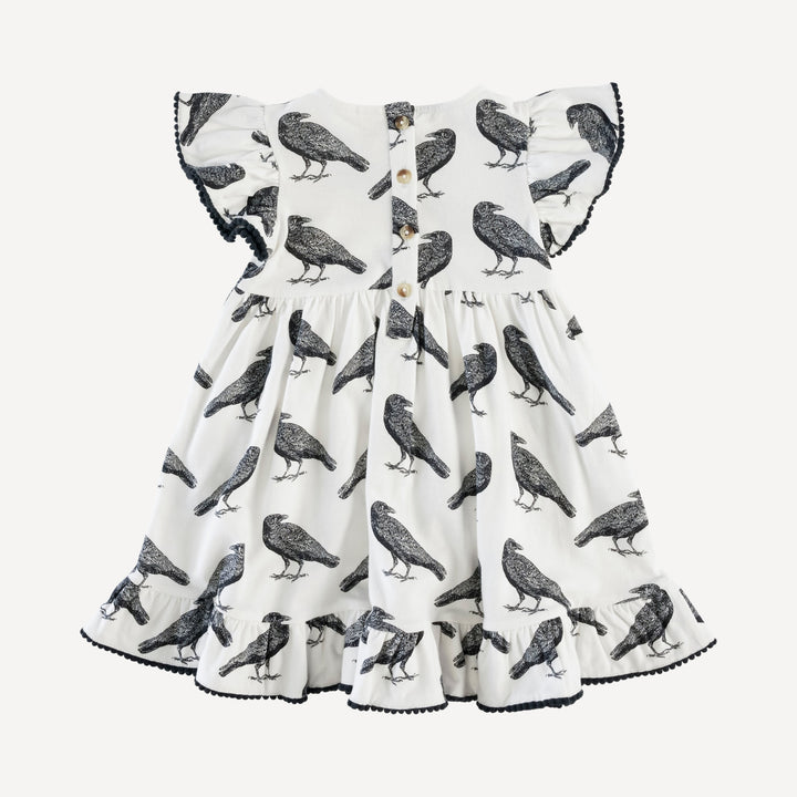 flutter sleeve pom pom pinafore dress | raven | organic cotton jersey