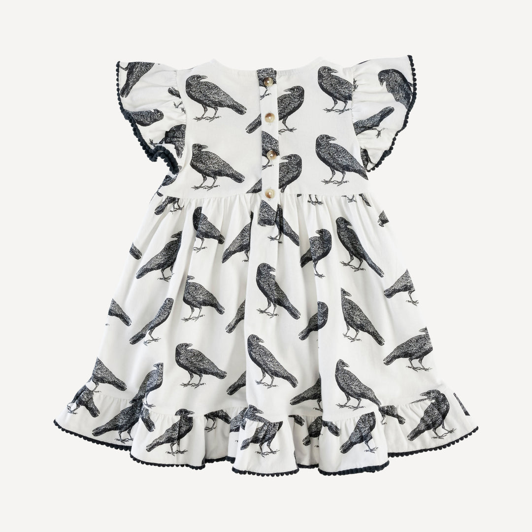 flutter sleeve pom pom pinafore dress | raven | organic cotton interlock