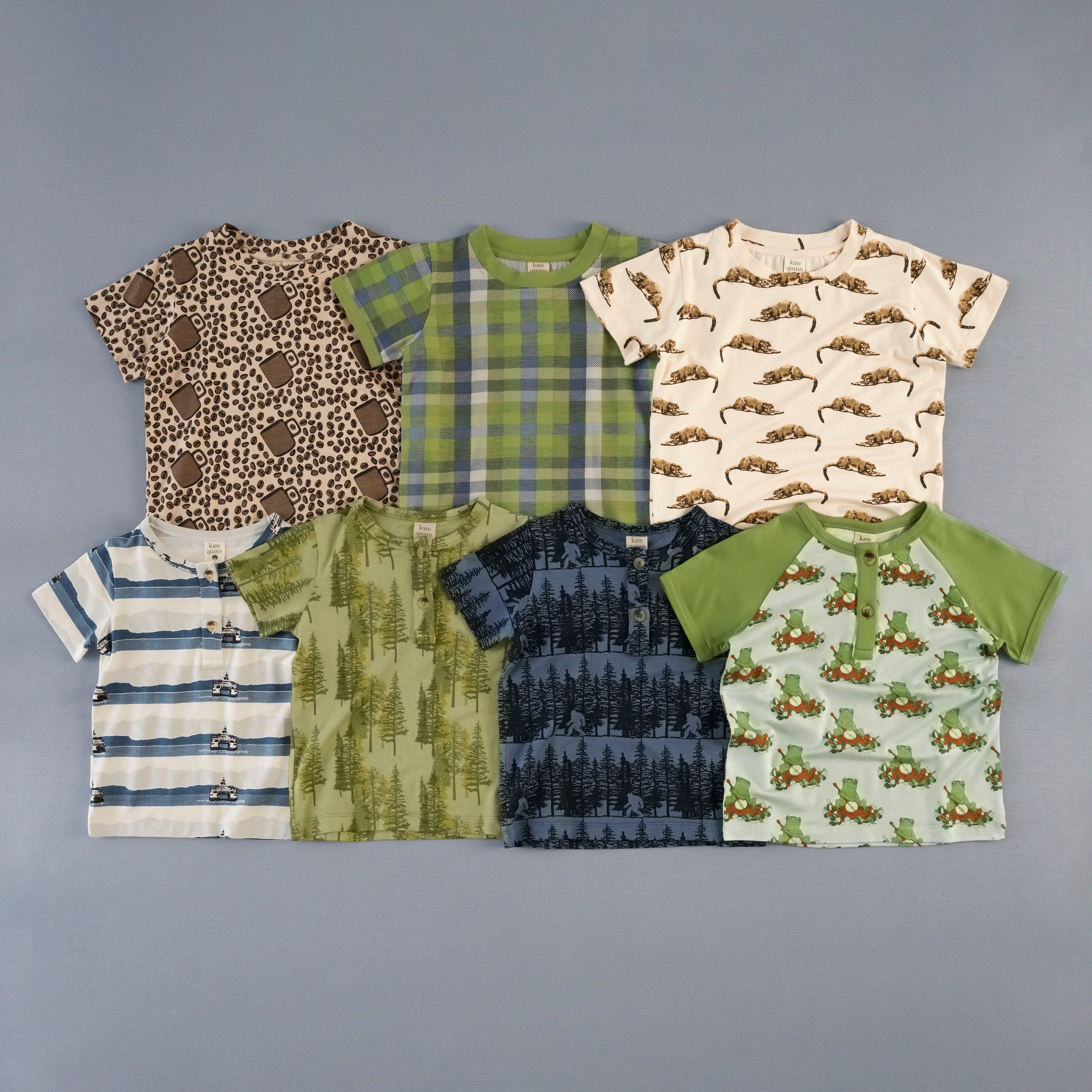 Collection of children's patterned shirts on a gray background
